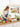Woman preparing food in a kitchen with portable rolling smart TV displaying multiple angles of the same scene.